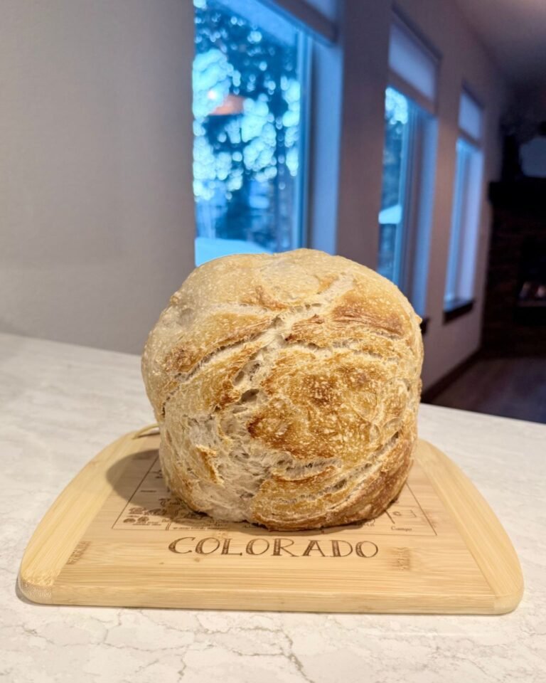 Freshly baked artisan bread on a Colorado cutting board