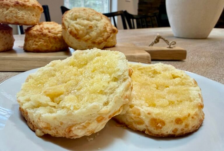 British cheese scone cut open on a plate and buttered