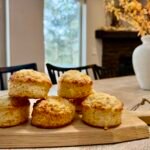 British cheese scones piled up on a wooden serving board