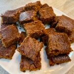 Classic British gingerbread cut into small squares on a plate