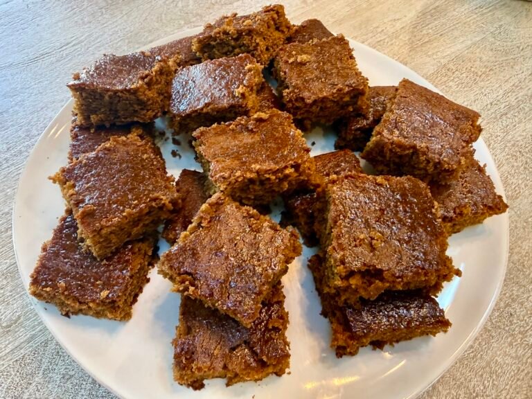 Classic British gingerbread cut into small squares on a plate